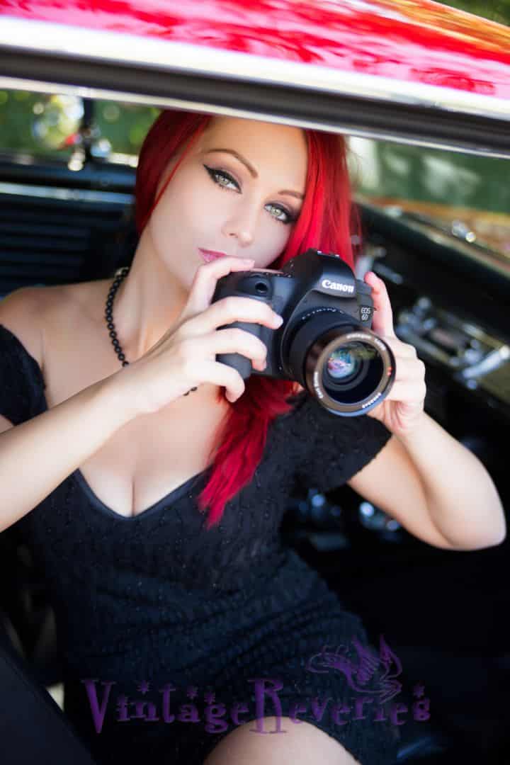Red haired model with a matching red vintage car