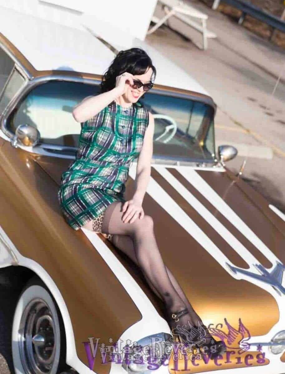 Snapshots of a pinup model wearing a 1960s Plaid Sheath Dress on a gold car (Rebekah Liegh)