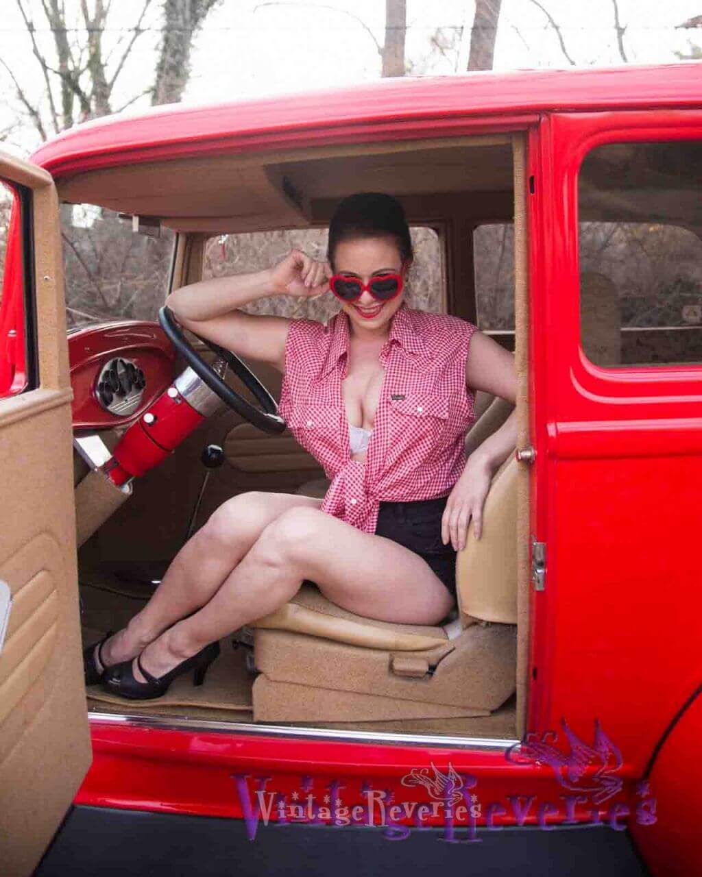 model in red car