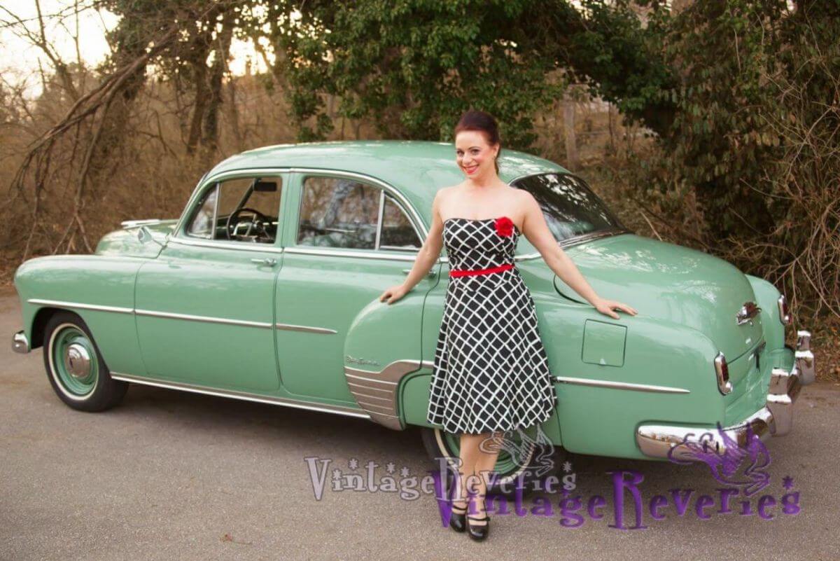 Pinup pics of June Ann with 2 vintage cars, a black Bel Aire and a green Chevrolet